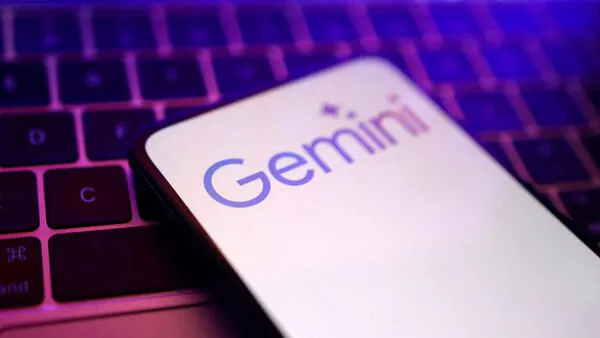 Google Gemini logo on smartphone placed over keyboard, representing India’s shift to Google’s AI platform